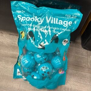 Spooky Village 18 count pre-filled teal pumpkin capsules assorted squishy toys